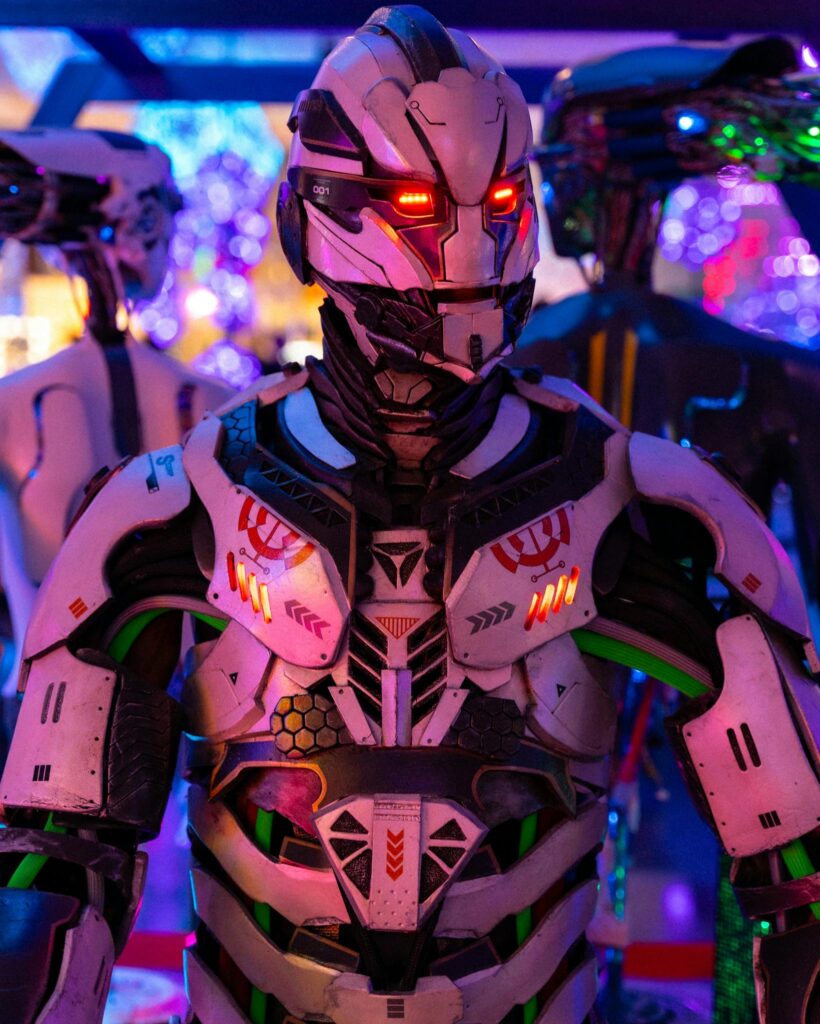A futuristic robot dressed in sci-fi armor illuminated by vibrant neon lights, showcasing cutting-edge technology.